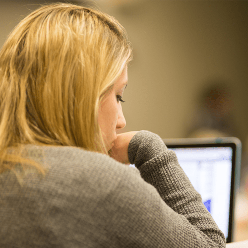 A woman works on a laptop