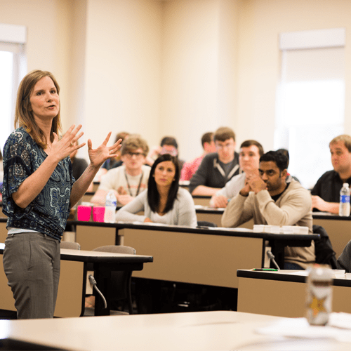 A professor lecturing a class of students