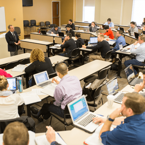 A wide-angle shot of a professor teaching a class of students