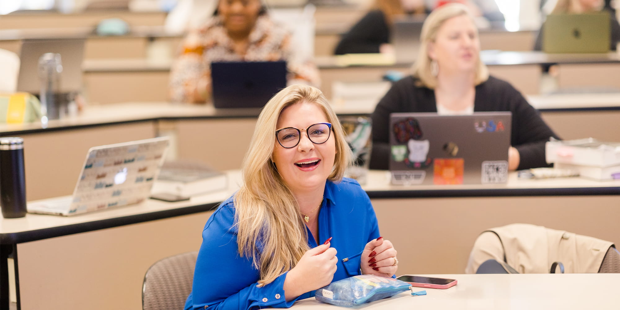 student-at-table-smiling.jpg